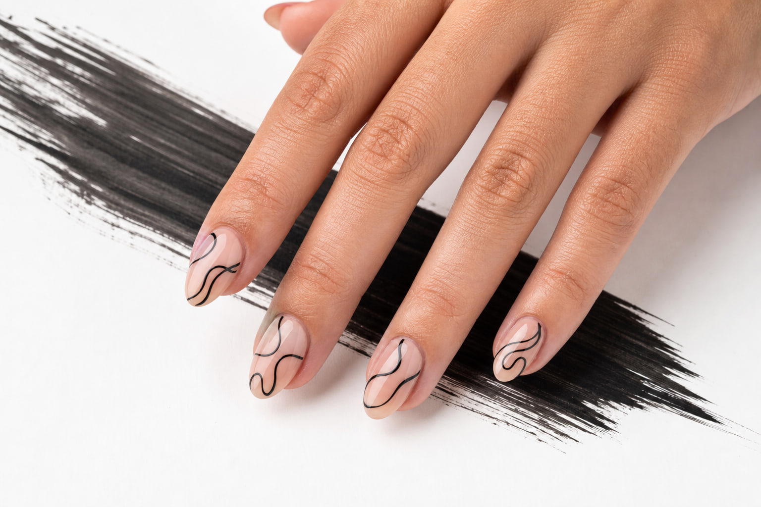 Sheer nude manicure with flowing black line art