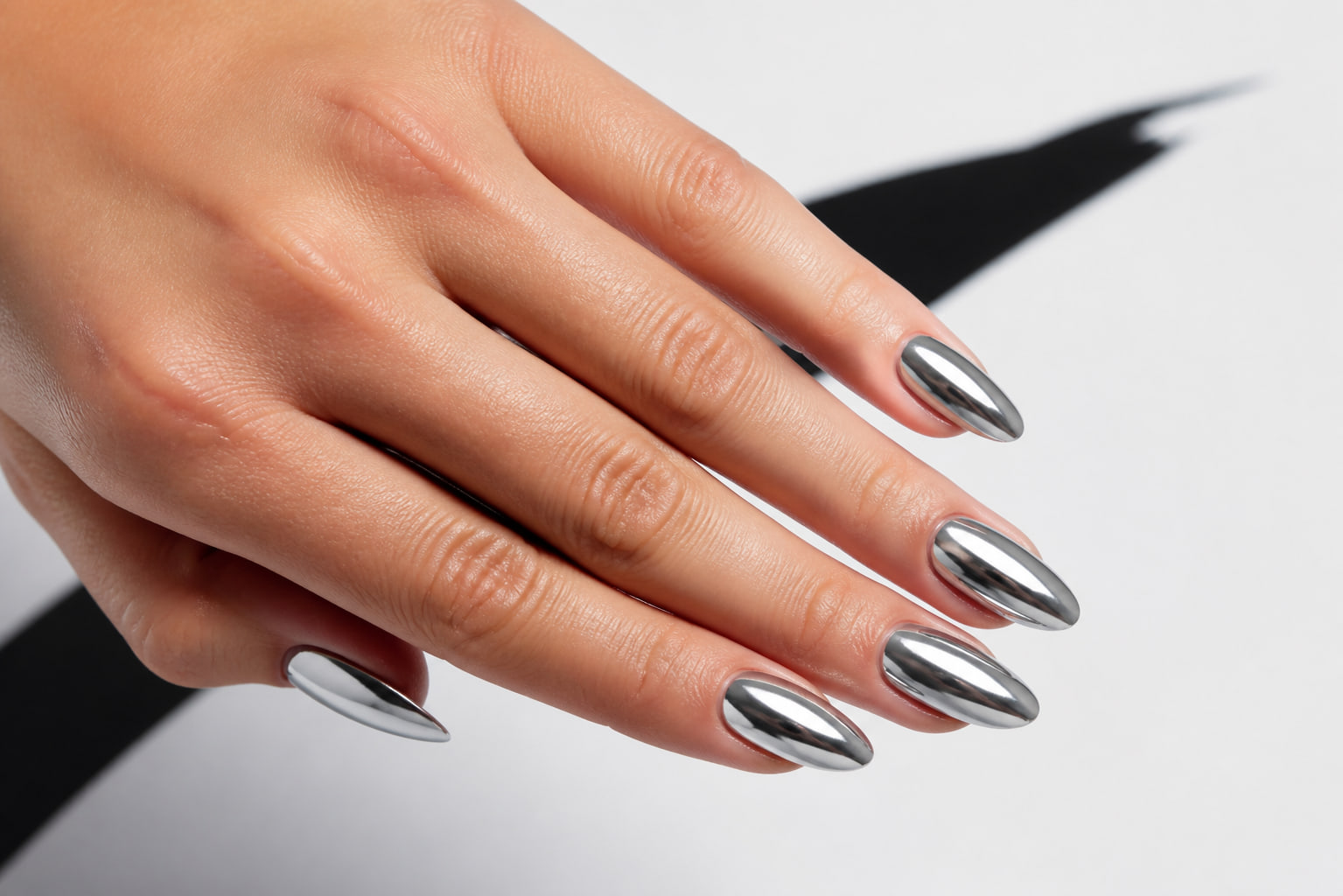 Reflective silver chrome almond manicure